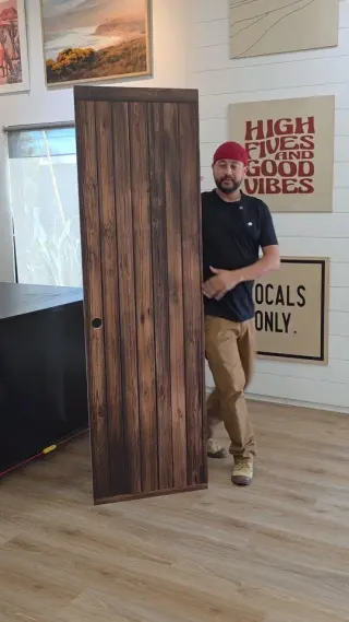 A member of the team with a wooden door printed for a school play