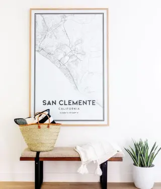 Large oak-framed San Clemente map print above an entry console