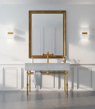 gold leaf framed mirror over a marble console, symmetrical white panelled wall