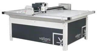 The Valiani Nexus Edge computerised mat cutter, its cutting head on the rail above a white bed