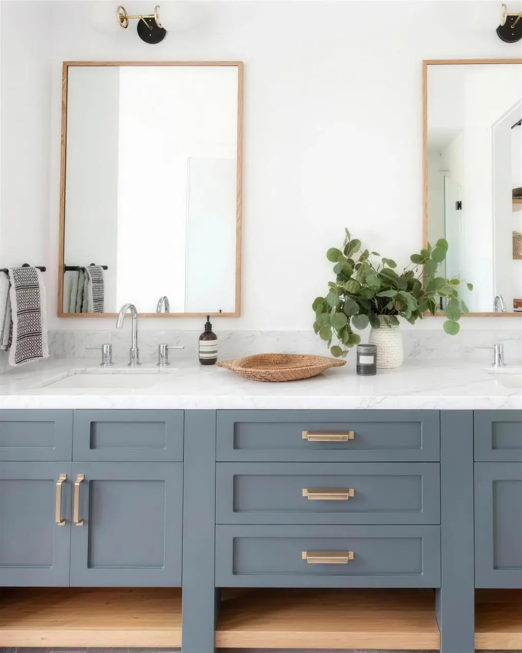Two oak-framed mirrors above a double vanity